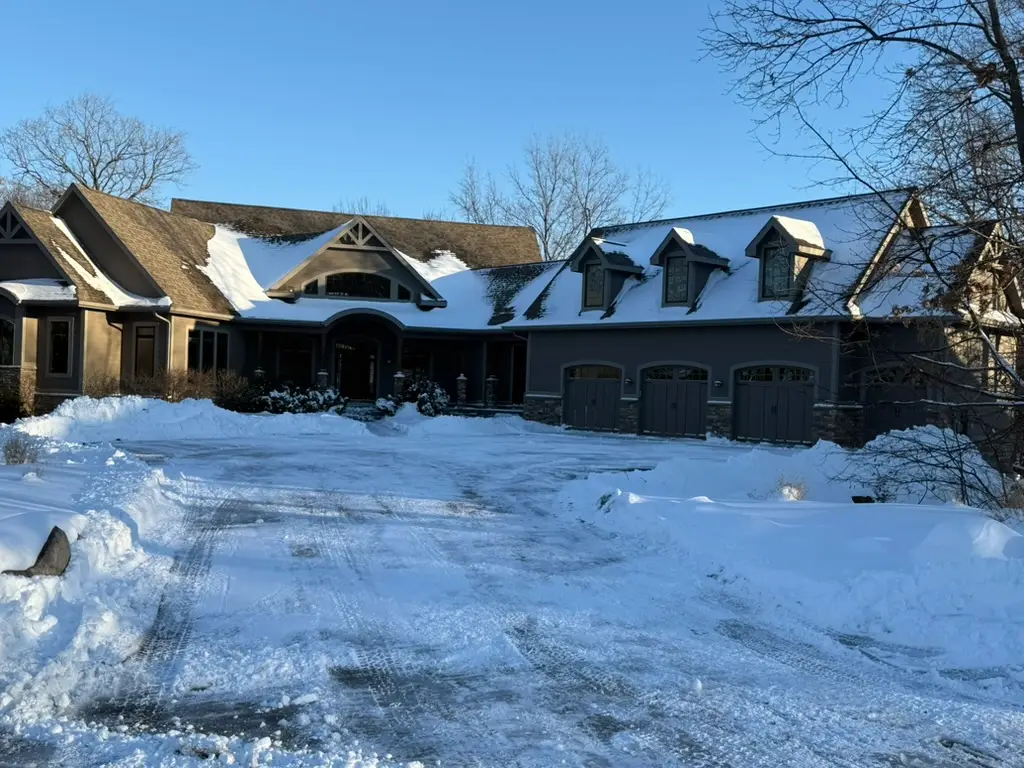 Residential driveway cleared of snow in Polk City, IA by Stretch Property Maintenance