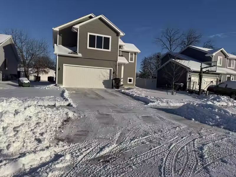 After: the same Johnston, IA driveway plowed and cleared by Stretch Property Maintenance