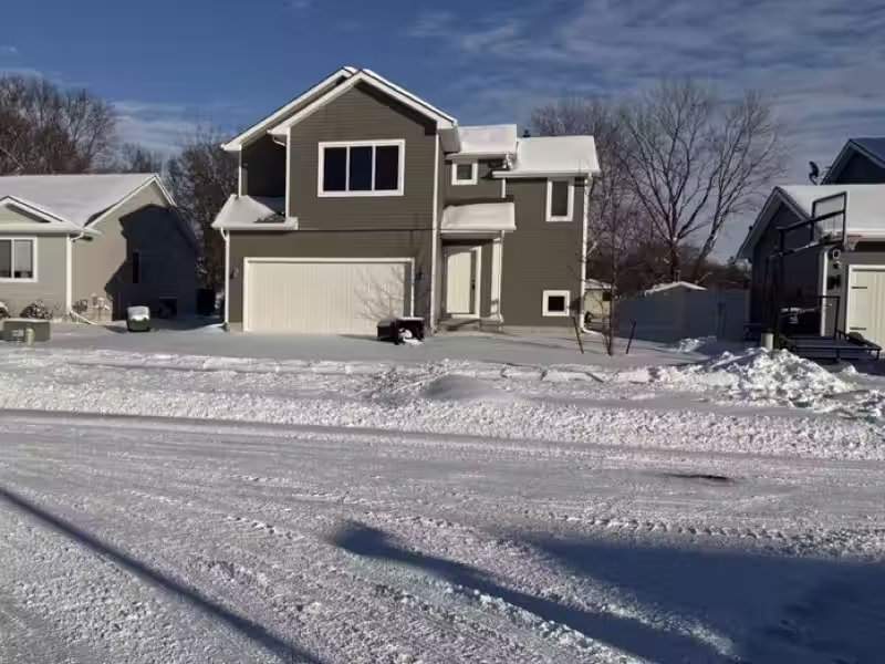 Before: driveway covered in snow at a home in Johnston, IA